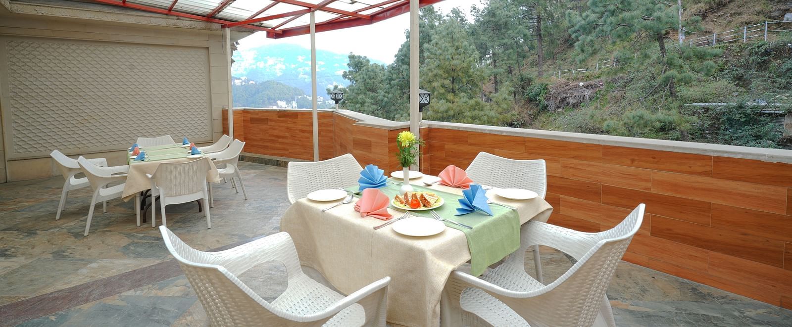 Dining setup on the terrace with cutlery placed on the table at DLS Hotels The Rock Castle.